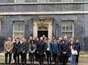 Sudents stood outside 10 Downing Street in London.