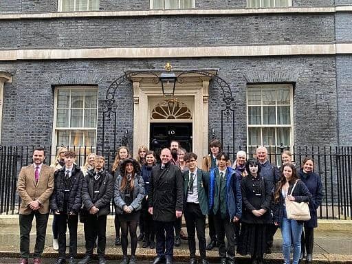 Sudents stood outside 10 Downing Street in London.