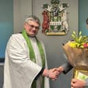 Outgoing chairman Coun Stephen Bunney receives flowers at the end of his term, pictured with Rev David Cotton, council chaplain. Photo: WLDC