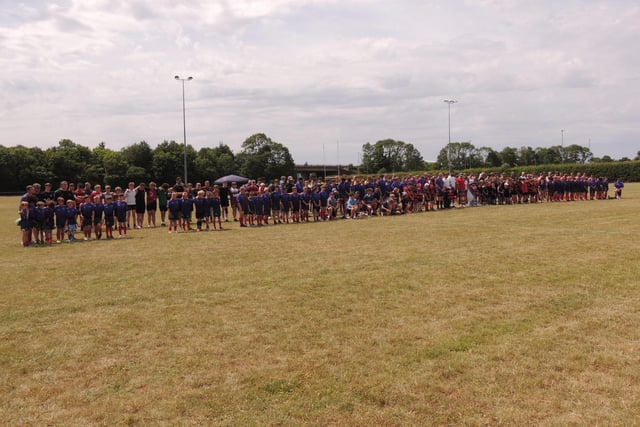 Teams attending the Will Ray Memorial Rugby Sevens Tournament pause for a minute's silence. Photo: Andy Hubbert