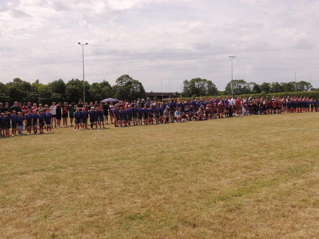 Teams attending the Will Ray Memorial Rugby Sevens Tournament pause for a minute's silence. Photo: Andy Hubbert