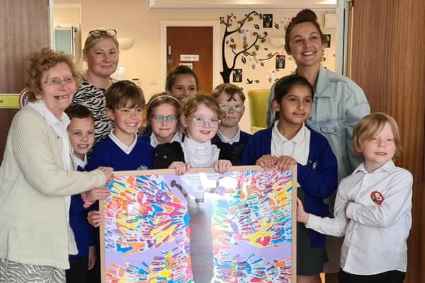 Resident Sylvia (left) with a group of children from Ormiston South Parade Academy