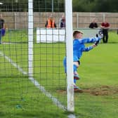 Liam Flitton dives to make a crucial save in the shoot-out. Photo: Steve W Davies Photography.