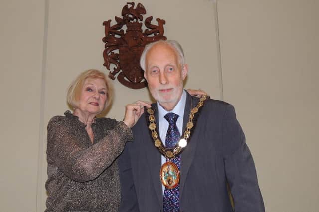 Outgoing chairman of NKDC, Coun Lucille Hagues, passes the chain of office to new chairman Coun Mike Clarke.