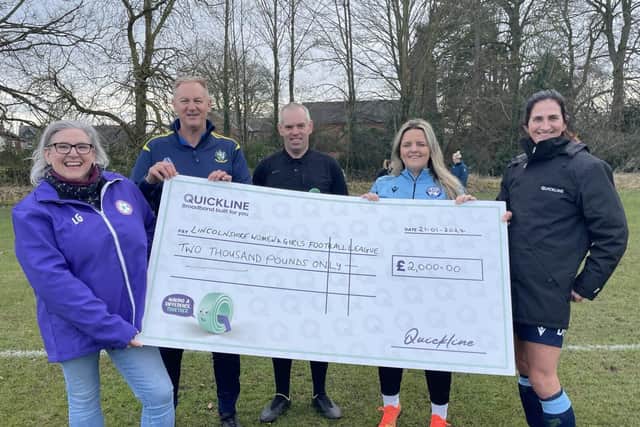 LWGFL representatives accept the sponsorship cheque from Quickline Communications.