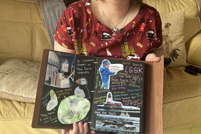 Charlotte with one of Charlie's memory books.