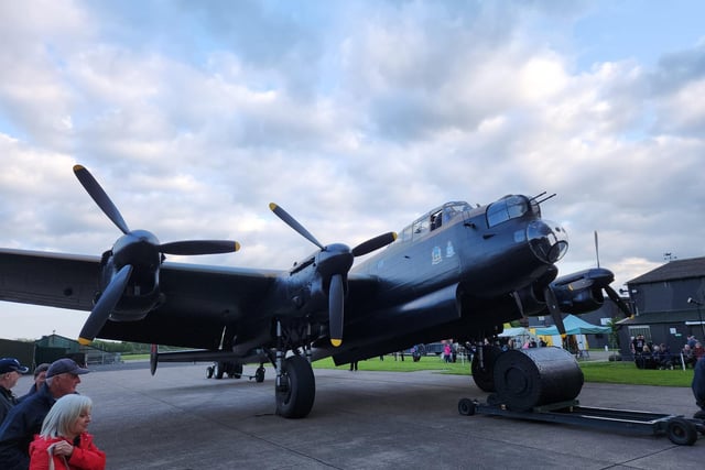 The 'Just Jane' Lancaster at East Kirkby Aviation Centre is taxied out of the hanger to greet the Lancaster flying over.