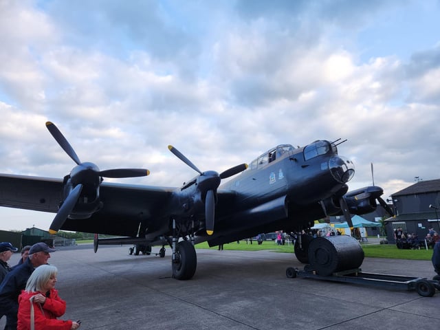 The 'Just Jane' Lancaster at East Kirkby Aviation Centre is taxied out of the hanger to greet the Lancaster flying over.
