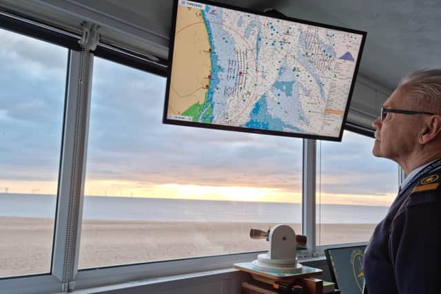 Senior watchkeeper Ian Granville Whalley examining a monitor showing activity in the Wash.