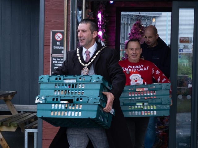 Mayor of Skegness Coun Adrian Findley helping to load the van.