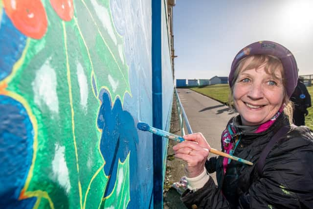 Painting volunteer Andrea Jennings.