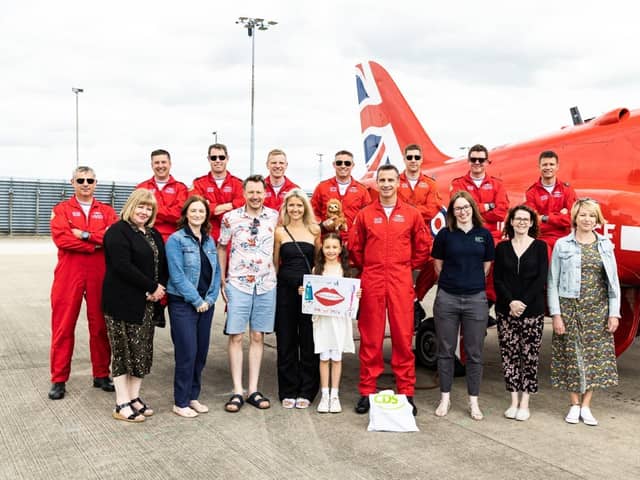 Sofia with her parents and her winning poster, alongside CDS, Lincolnshire County Council and the RAF Red Arrows.