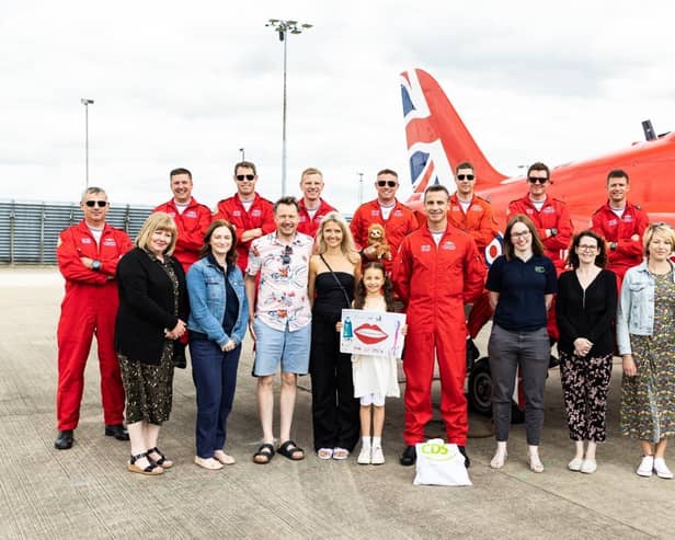 Sofia with her parents and her winning poster, alongside CDS, Lincolnshire County Council and the RAF Red Arrows.