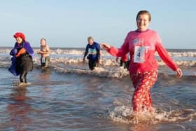 Brave Carol Frisby emerges from the sea after a previous Big Dip event in Mablethorpe on New Year's Day.