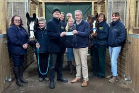 Alexandra Lodge Master Richard Diggle and his predecessor Chris Woodrow presented the cheque to Paul Brett watched by founder Liz Dixon-Spain and volunteers Andrea Brett, Sara Woodrow, Ginny Gray, Fiona Ralling, and Jane Goodger - together with ponies Cashew and Molly.