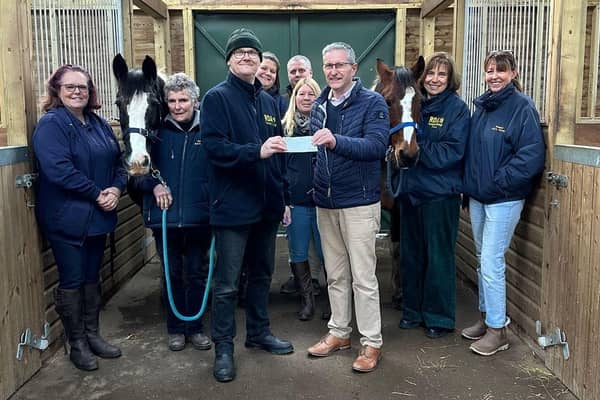 Alexandra Lodge Master Richard Diggle and his predecessor Chris Woodrow presented the cheque to Paul Brett watched by founder Liz Dixon-Spain and volunteers Andrea Brett, Sara Woodrow, Ginny Gray, Fiona Ralling, and Jane Goodger - together with ponies Cashew and Molly.