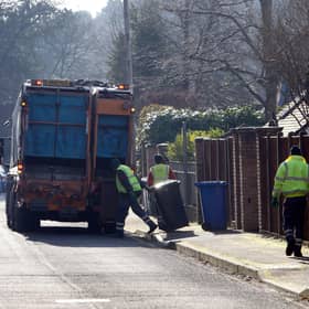 Council workers empty bins in Sunningdale, Berkshire .