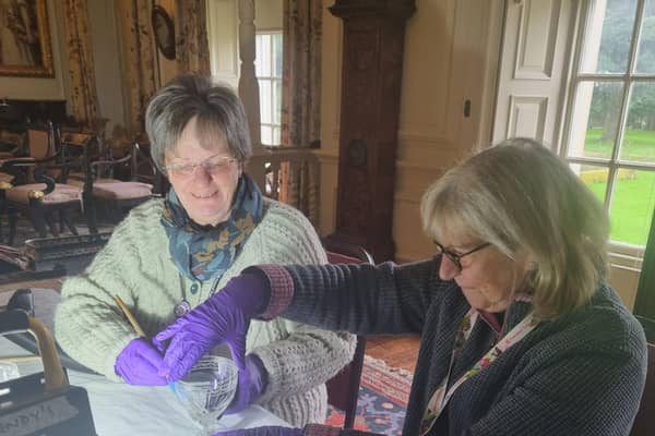 Jenny Humphrey  and Sue Clarke cleaning crystal.