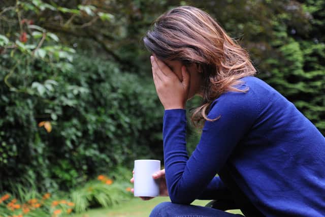 PICTURE POSED BY MODEL. A woman showing signs of depression.