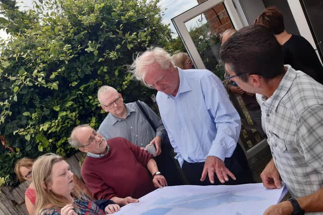 Campaigners show Sir Edward Leigh the solar farm plans.