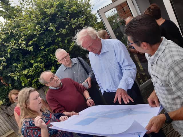 Campaigners show Sir Edward Leigh the solar farm plans.