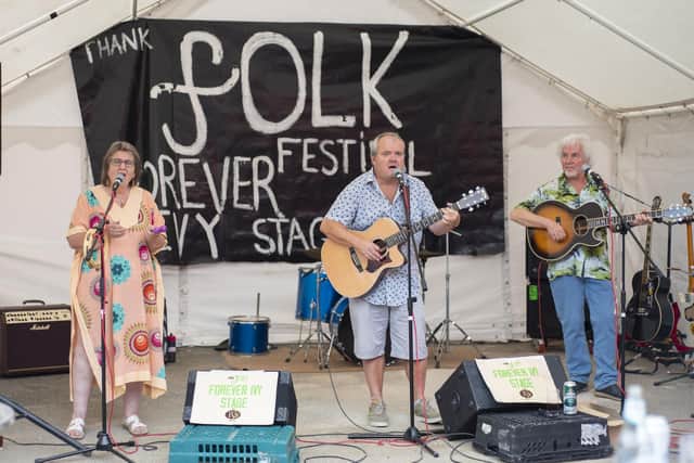 Performers on the Forever Ivy Stage at the folk festival. Dave Smith Trio band with lead singer Dave Smith (middle), Patty Vetta (left) and Tony Harris (right). The band's first gig as a trio. Photo: Holly Parkinson.