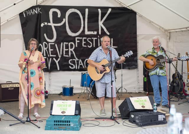 Performers on the Forever Ivy Stage at the folk festival. Dave Smith Trio band with lead singer Dave Smith (middle), Patty Vetta (left) and Tony Harris (right). The band's first gig as a trio. Photo: Holly Parkinson.