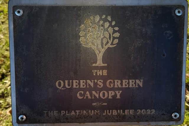 The Queen's Green Canopy (QGC) plaque.
