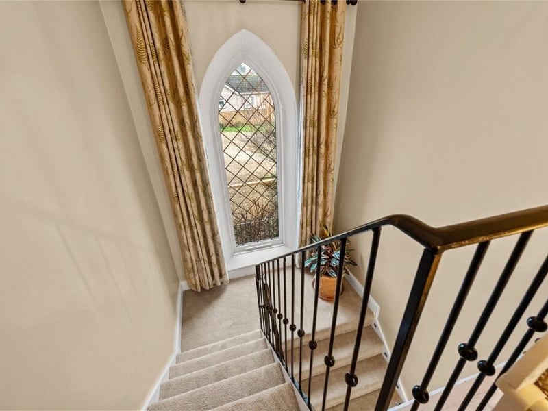 The church-style window on the half-landing.