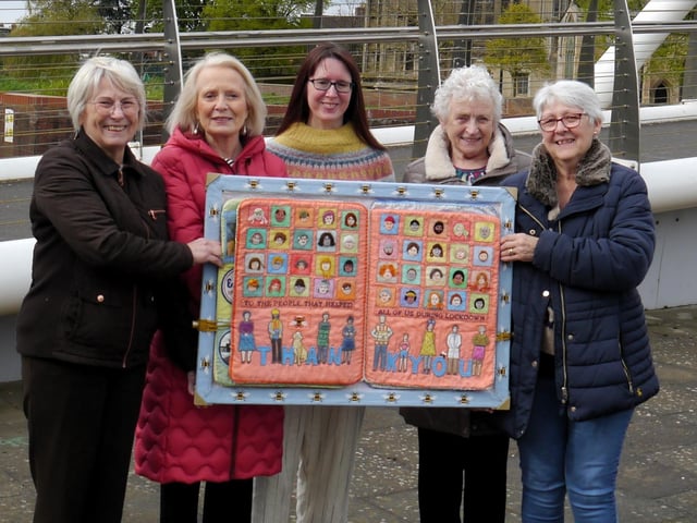 Each of the four books is almost two foot high and take between 12 and 18 months to create. Pictured with one of them are Boston Stitchers (from left) Maureen Hill, Janet Corcoran, Johanna Taylor, Thora Fleming, and Judy Carrott.