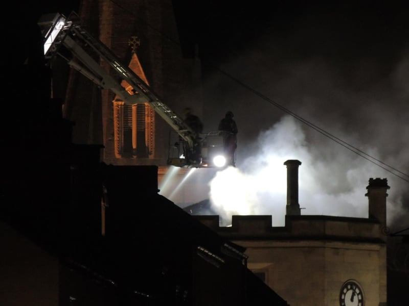 Firefighters survey the wrecked Sessions House from above. Photo: Andy Hubbert