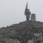 On top of the world - Skegness Royal British Legion Standard Bearer Kevin Wooley, after climbing  Ben Nevis.