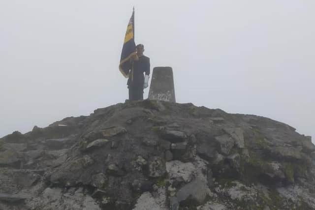 On top of the world - Skegness Royal British Legion Standard Bearer Kevin Wooley, after climbing Ben Nevis.