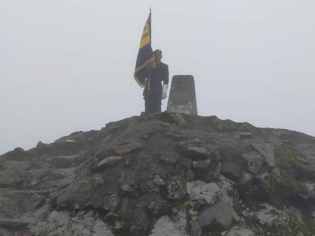 On top of the world - Skegness Royal British Legion Standard Bearer Kevin Wooley, after climbing  Ben Nevis.