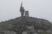 On top of the world - Skegness Royal British Legion Standard Bearer Kevin Wooley, after climbing  Ben Nevis.