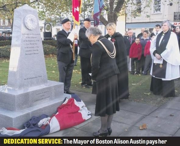 A scene from the unveiling of a new war memorial in Boston's Wide Bargate, marking the 100th anniversary of the start of the First World War. The polished, granite memorial was funded entirely by donations. The Mayor of Boston, Coun Alison Austin, is pictured paying her respects after carrying out the unveiling.