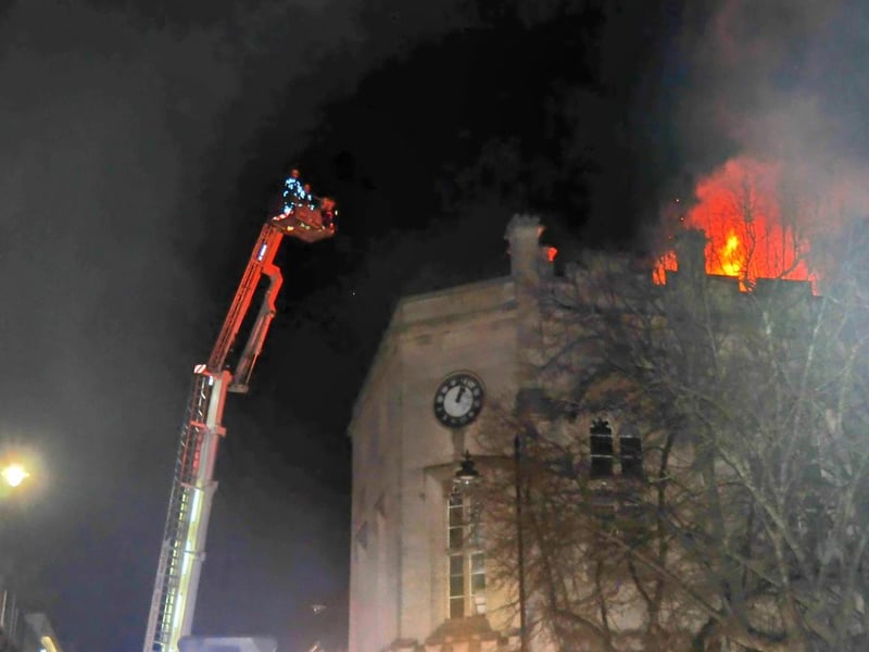 Firefighters tackling the rooftop blaze. Photo: Roderick Carlyle