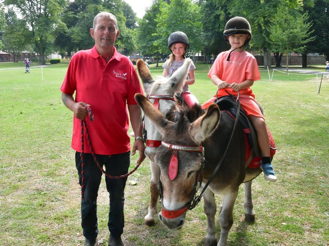 Mike Thomes of Mike's Donkeys, Everlyn Saxby, aged four, of Heckington, Freddie Hirst, aged seven, of Boston.