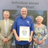Nigel Peart (centre) receives his award from county council leader Cllr Martin Hill OBE and chairman Cllr Alison Austin.