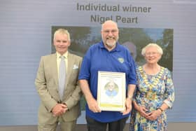 Nigel Peart (centre) receives his award from county council leader Cllr Martin Hill OBE and chairman Cllr Alison Austin.