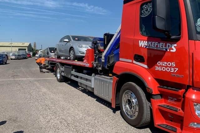A seized vehicle being removed from the site.