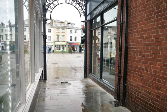 The new yorkstone paving setts glistening in the rain.