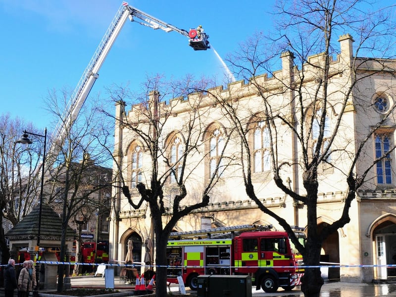Damping down this morning at the Market Place. Photo: Roderick Carlyle