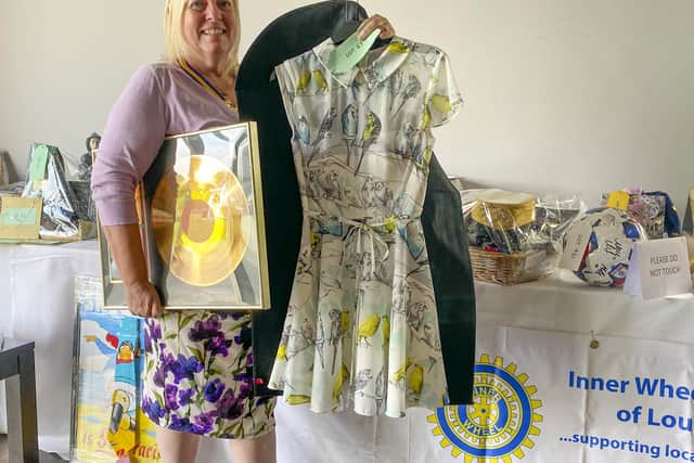 Inner Wheel President Chris Suich with a Gold Disc and the "Budgie" dress donated by Keeley Donovan.