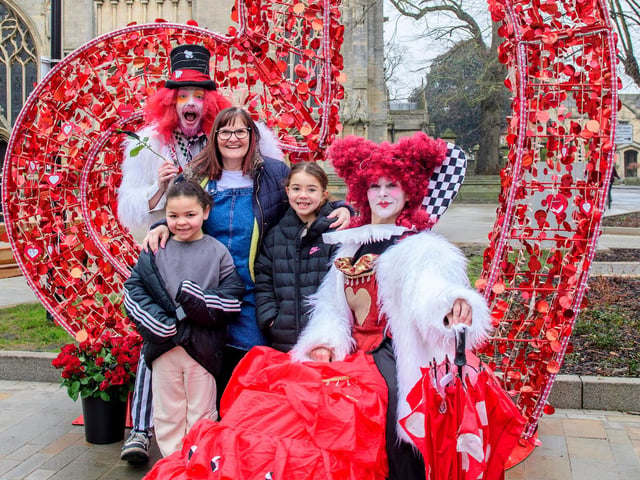 Rhubarb Theatre's Queen of Hearts and Mad Hatter greet families in the market Place around the heart seat. Photo: NKDC