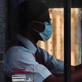 A bus driver wears a face mask as a precaution as he drives a bus on Oxford Street in London on May 2, 2020, as life in Britain continues during the nationwide lockdown due to the novel coronavirus pandemic. - Britain's overall death toll from the coronavirus outbreak rose by 739 to 27,510 on May 1. (Photo by JUSTIN TALLIS / AFP) (Photo by JUSTIN TALLIS/AFP via Getty Images)