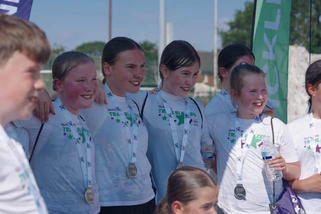Medal winners - children with their medals at the finish line of the triathlon