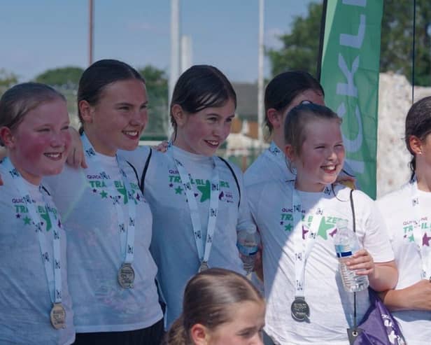 Medal winners - children with their medals at the finish line of the triathlon