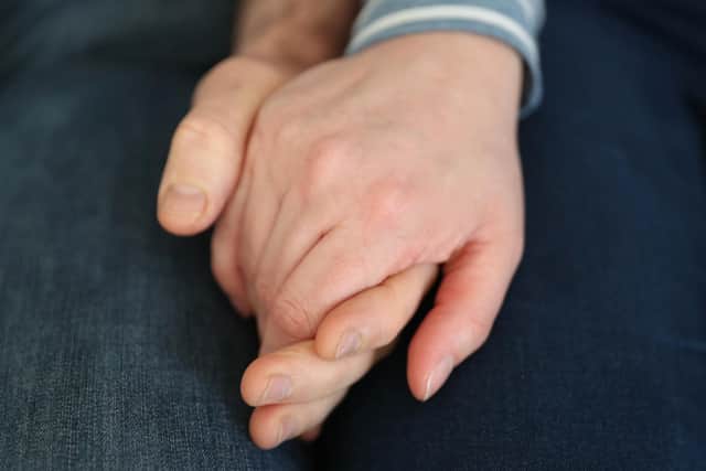 File photo dated 05/02/20 of a married couple holding hands, as couples could receive financial support from their partners if relationships break down, a report aimed at reforming the law for cohabiters in Scotland has suggested.