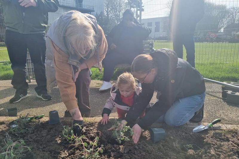 Kavenna Stacey, 2, with Sally Powell (right) helping with the planting.